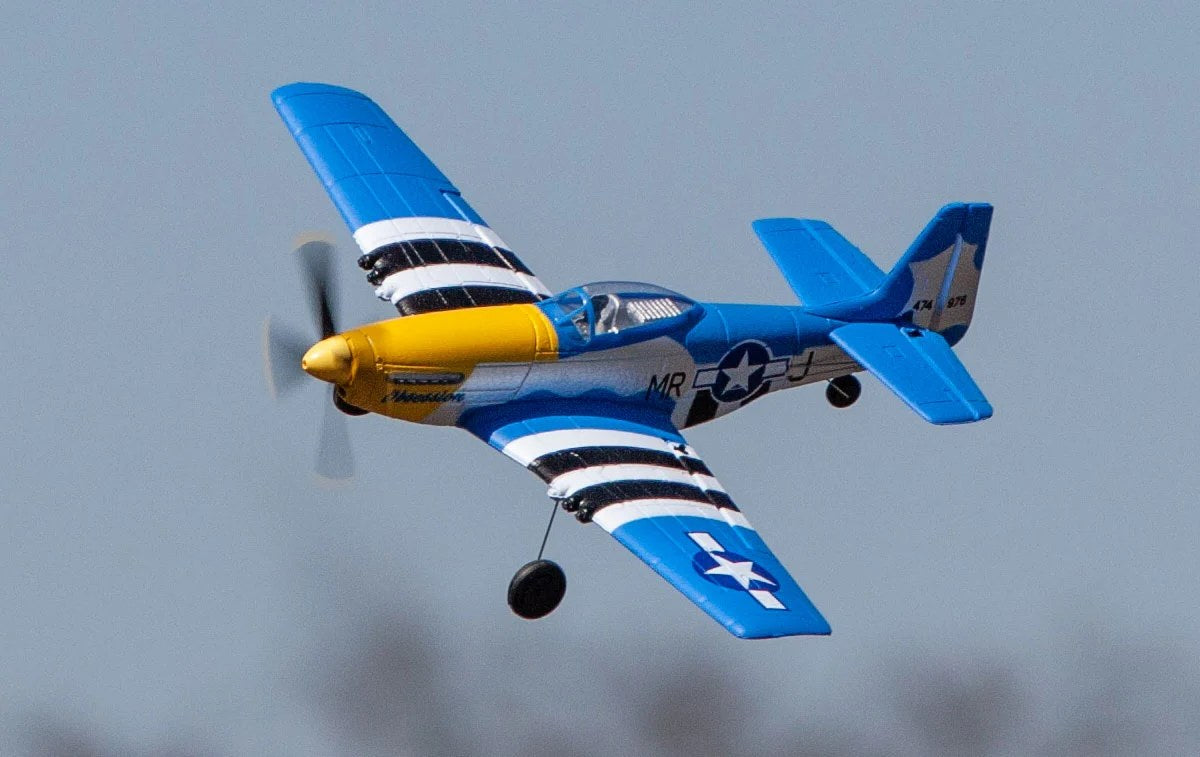Blue and yellow RC plane in flight